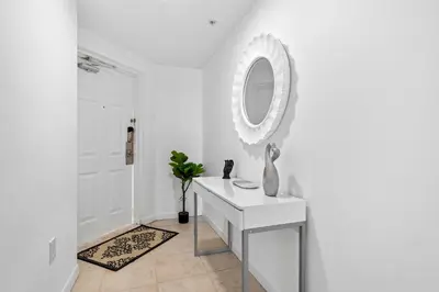 a white room with a white vanity and a mirror at Waterfront Luxury 2-Bedroom Condo Sunny Isles Beach in Miami Beach