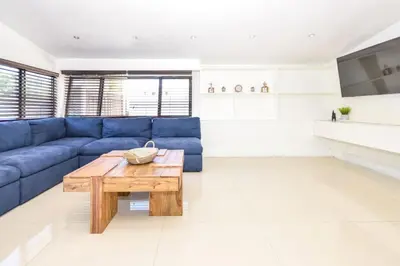 a living room with a blue couch and a wooden coffee table at Five Bedroom Villa With POOL In Highland Lakes Near Aventura Mall in Miami