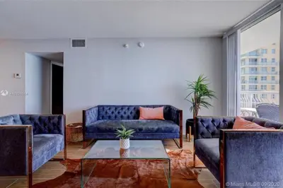 a living room with two blue couches and a table at 3BR Airbnb Friendly Condo with Ocean View and Balcony in Miami