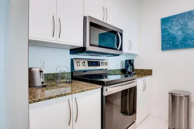 a kitchen with a stove and a microwave at Penthouse with Ocean and City Views in Lux Miami Brickell Sleeps 4 in Miami