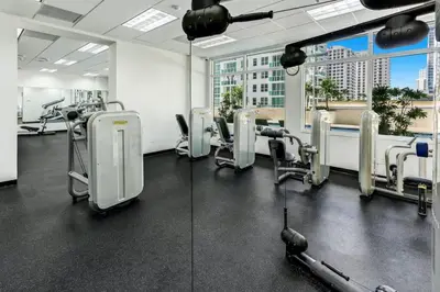 a gym with treadmills and machines in a building at Penthouse with Ocean and City Views in Lux Miami Brickell Sleeps 4 in Miami