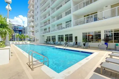 a swimming pool in front of a building at Penthouse with Ocean and City Views in Lux Miami Brickell Sleeps 4 in Miami
