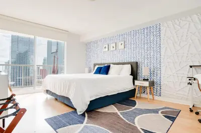 a bedroom with a large bed with blue and white walls at Ocean and City Views Lux Miami Brickell Condo Sleeps 4, King Bed in Miami