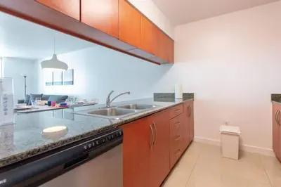 a kitchen with a sink and a dishwasher at Sunshine Ocean and City Views 1 BR Paradise with Parking in Miami