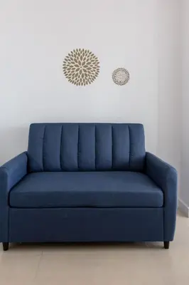 a blue couch sitting in a living room at Sunshine Ocean and City Views 1 BR Paradise with Parking in Miami