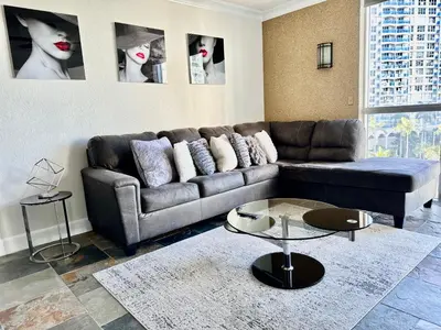 a living room with a couch and a table at Luxury Beachfront Family-Friendly Condo in Hollywood