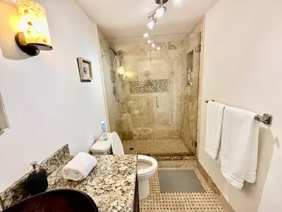 a bathroom with a toilet and a shower at Luxury Beachfront Family-Friendly Condo in Hollywood