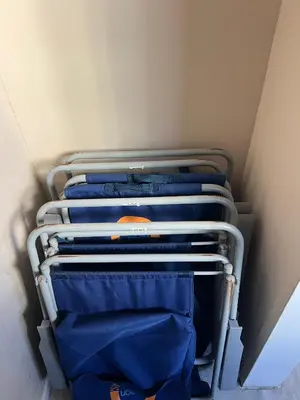 a group of blue shirts on a rack in a closet at Luxury Beachfront Family-Friendly Condo in Hollywood