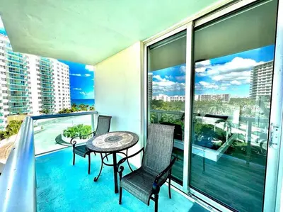 a balcony with a table and chairs on a balcony at Luxury Beachfront Family-Friendly Condo in Hollywood