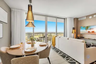 a dining room with a table and chairs and large windows at Amazing Pools - Bay View - Parking Included in Hollywood