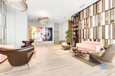 a living room with a pink couch and chairs at Amazing Pools - Bay View - Parking Included in Hollywood