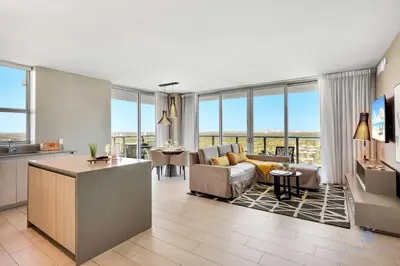 a large living room with a couch and a table at High Floor with Stunning Views, Amazing Pools in Hollywood