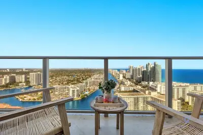 a balcony with a table and a view of the ocean at High Floor with Stunning Views, Amazing Pools in Hollywood