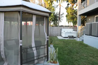 a gazebo in the backyard of a house at Modern Miami Retreat, Hot Tub and Gazebo Oasis in Miami