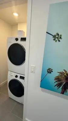 a kitchen with two microwaves and a painting on the wall at Sky-High oasis heated Pool & Gym Miami Skyline Vista in Miami