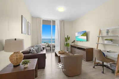 a living room with a couch and a table at Spectacular Beach View - Amazing Rooftop Pool in Hollywood