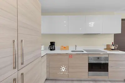 a kitchen with white appliances and wooden cabinets at Spectacular Beach View - Amazing Rooftop Pool in Hollywood