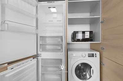 a laundry room with a washer and a microwave at Spectacular Beach View - Amazing Rooftop Pool in Hollywood