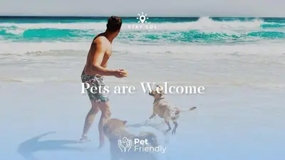 a man and a dog playing on the beach at Spectacular Beach View - Amazing Rooftop Pool in Hollywood