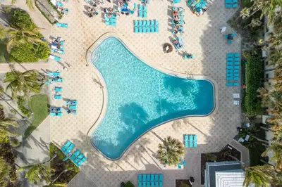an overhead view of a swimming pool at a resort at Beachfront 1-Bedroom Apartment with Ocean View, Pool and Gym in Hollywood Beach in Hollywood