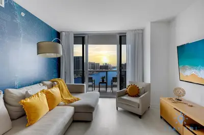 a living room with a couch and a table at Infinite View Balcony with Pool, Gym and Near Beach in Hallandale Beach
