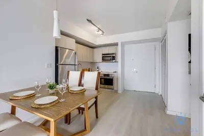 a kitchen and dining room with a table and chairs at Infinite View Balcony with Gym, Pool and Near Beach in Hallandale Beach