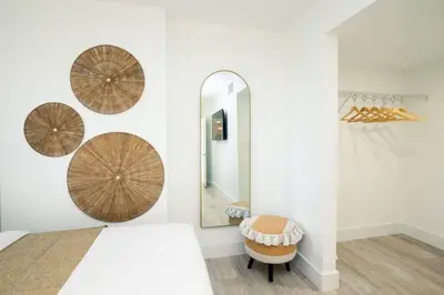 a bedroom with a bed and a mirror and a chair at City views at brickell miami in Miami