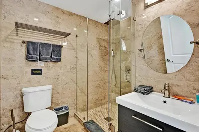a bathroom with a toilet and a sink and a shower at Deluxe Home Heated Pool & Jetted Tub near Beach in Dania Beach