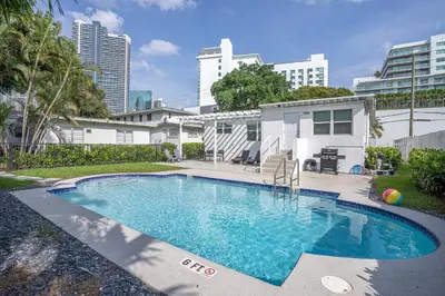 a swimming pool in the backyard of a house at Oia House Brickell Beach 10 minutes Pool Location in Miami