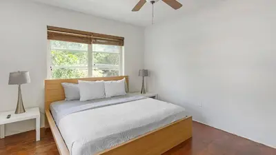 a white bedroom with a bed and a window at Brickell Tree Apartment Beach 10min Location Shops in Miami