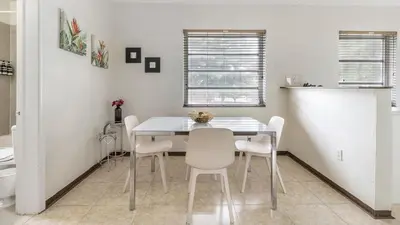 a dining room with a white table and chairs at Brickell 4ever Apartment Beach 10 minutes Location in Miami