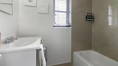 a white bathroom with a sink and a shower at Brickell 4ever Apartment Beach 10 minutes Location in Miami