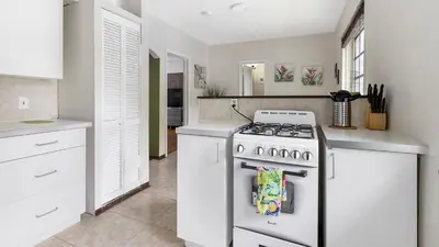 a kitchen with a white stove and white cabinets at Brickell 4ever Apartment Beach 10 minutes Location in Miami