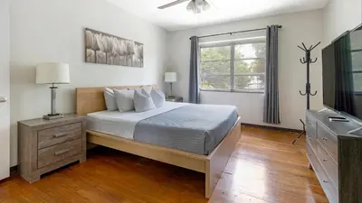 a bedroom with a bed and a television and a window at Brickell 4ever Apartment Beach 10 minutes Location in Miami