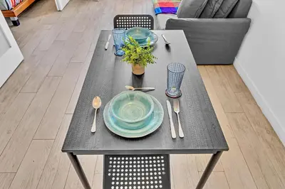 a table with a blue plate and spoon and fork and knife at Deluxe modern 1 bedroom in south beach in Miami Beach