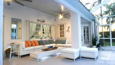 a living room with a couch and some windows at Home in Miami in Miami