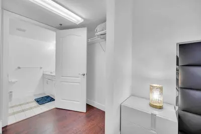 a white room with a bathroom with a toilet and a door at Central ocean view 3 bedrooms in Miami W Parking in Miami
