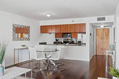 a kitchen and living room with a table and chairs at Superb unit, centrally located with parking in Miami