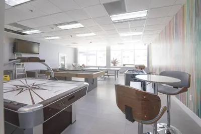 a restaurant with tables and chairs in a room at Superb unit, centrally located with parking in Miami