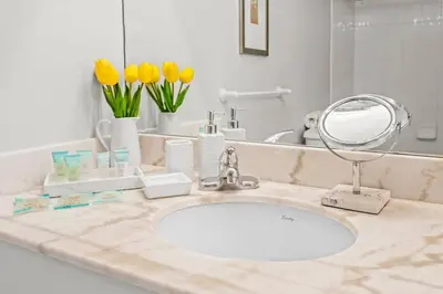 a bathroom counter with a sink and a mirror at Spacious Ocean view unit in the heart of Brickell in Miami