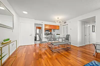 a living room with a table and a kitchen at Spacious Ocean view unit in the heart of Brickell in Miami