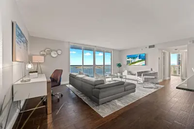 a large living room with a couch and a desk at Ocean view 35th floor, in the heart of Miami in Miami