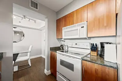 a kitchen with a white stove and a microwave at Ocean view 35th floor, in the heart of Miami in Miami