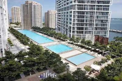 an aerial view of two pools in a city with buildings at Emblematic unit at Icon in the heart of Brickell in Miami