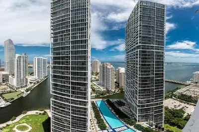 two tall buildings in a city next to a body of water at Emblematic unit at Icon in the heart of Brickell in Miami