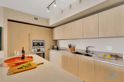 a kitchen with a counter with a bottle of wine at Insane Ocean View Balcony Beachfront Resort Pool in Hollywood