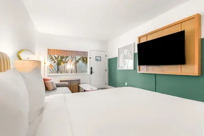 a bedroom with a bed and a flat screen tv at Aloha Fridays in Miami Beach