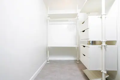 a closet with white cabinets and a floor at Franklin Suites South Beach in Miami Beach