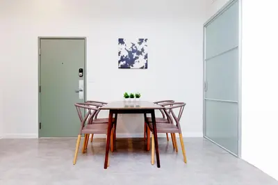 a dining room with a wooden table and chairs at Franklin Suites South Beach in Miami Beach