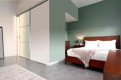 a bedroom with a bed and a sliding glass door at Franklin Suites South Beach in Miami Beach
